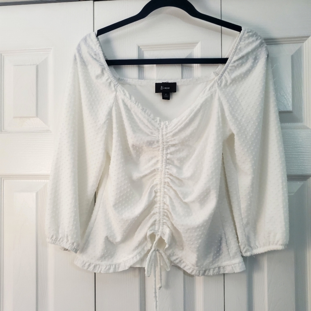 Quarter sleeve white shirt with dot detailing. Super cute for any occasion!
